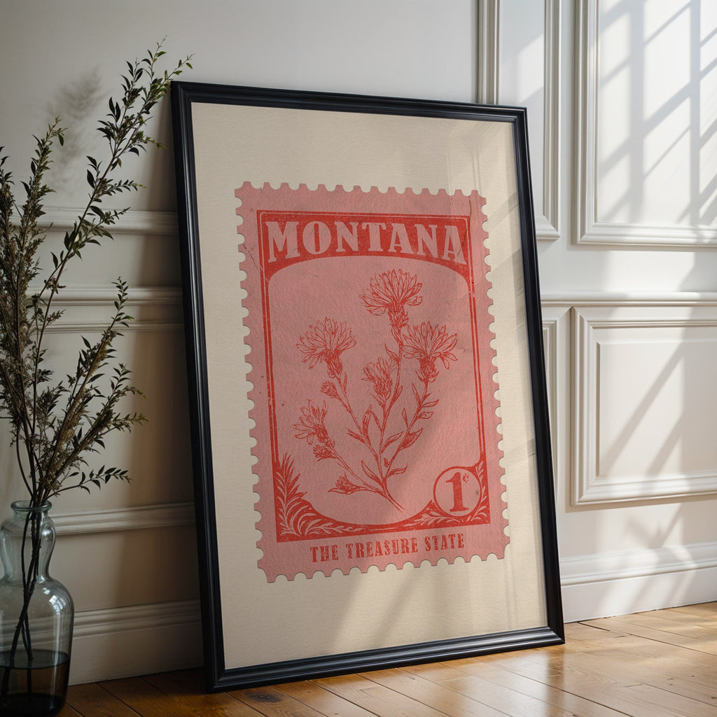 Montana state flower print in a black frame leaning against a white panelled wall beside olive branches