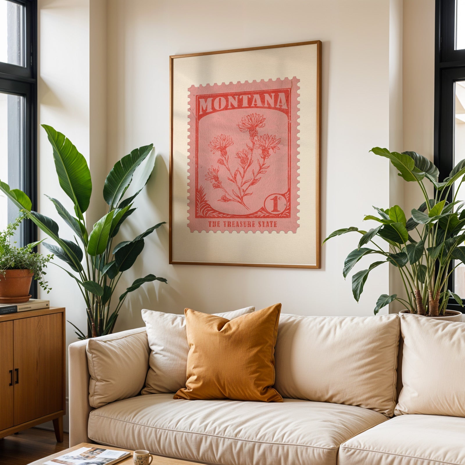 Montana state flower print framed above a cream sofa with an ochre cushion and large plants either side