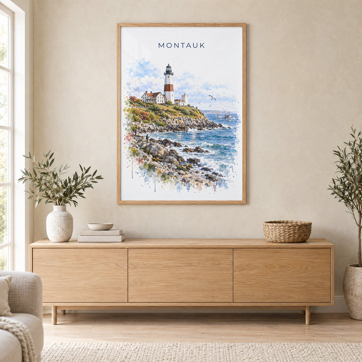 Montauk watercolor print in an oak frame above a light wood sideboard in a Scandinavian living room