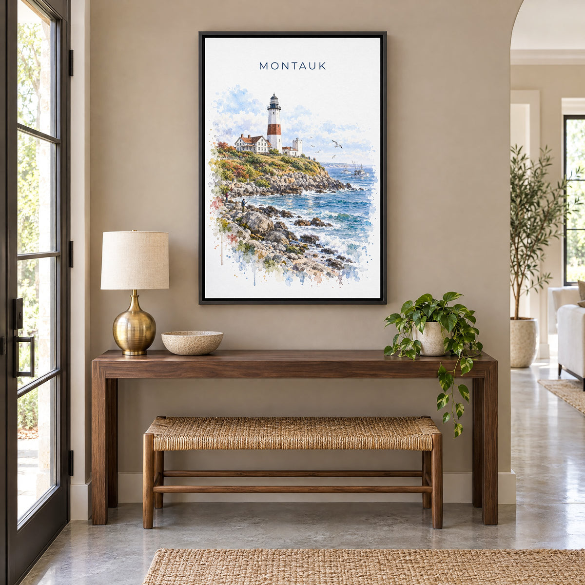Montauk watercolor print as a black floater canvas above a walnut console and woven bench in an entryway
