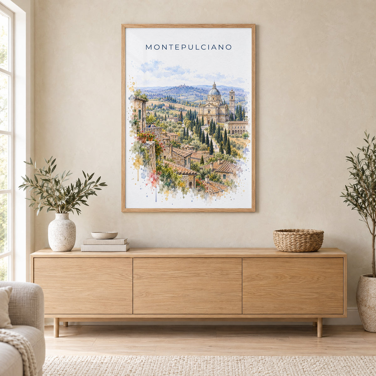 Montepulciano watercolor print in an oak frame above a light wood sideboard in a Scandinavian living room