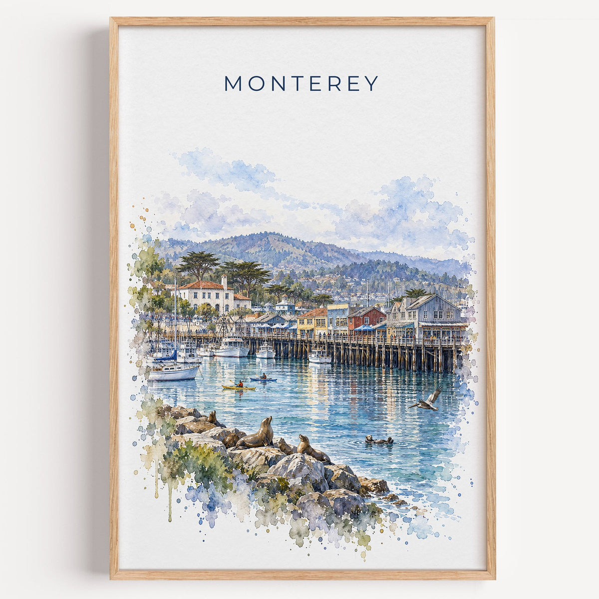 Monterey watercolor print in a light oak frame on a plain white wall