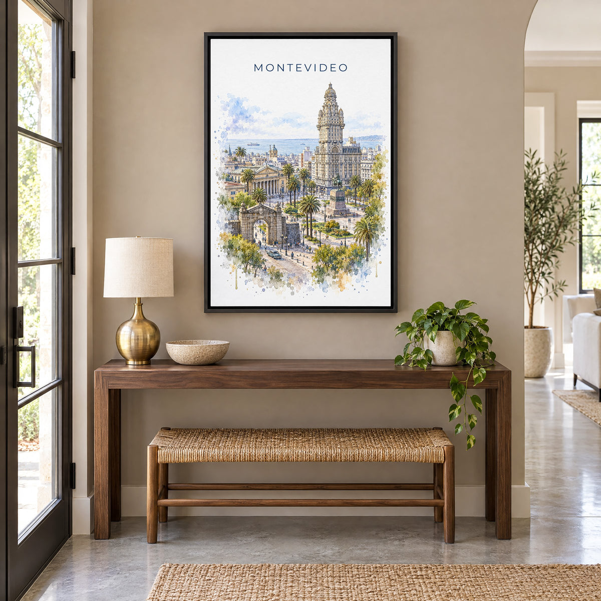 Montevideo watercolor print as a black floater canvas above a walnut console and woven bench in an entryway