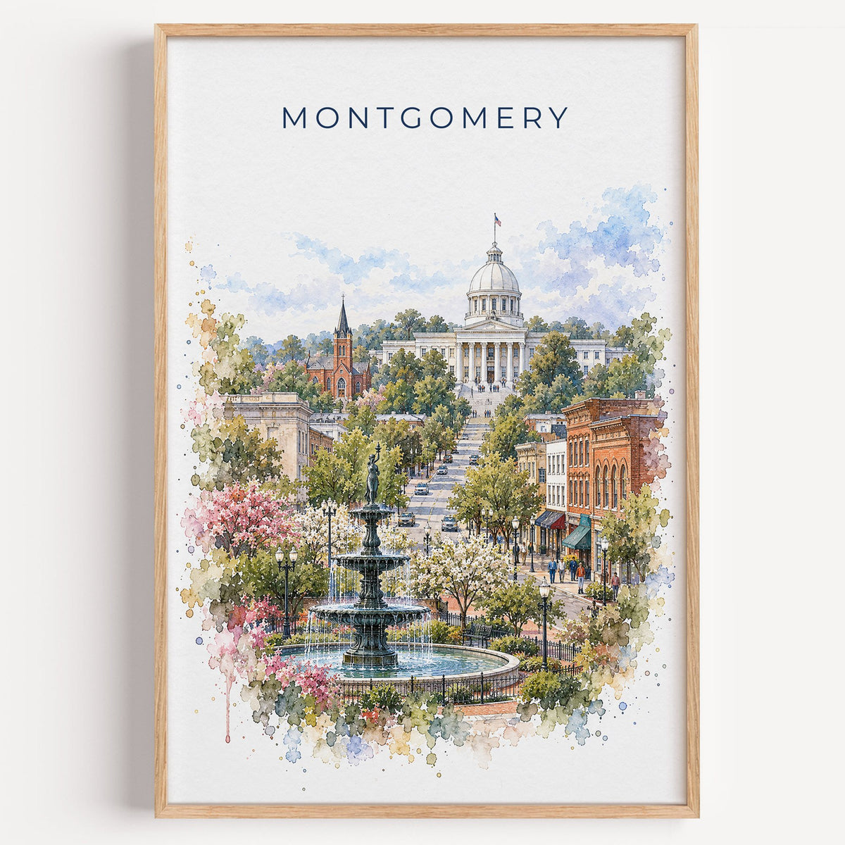 Montgomery, Alabama watercolor print in a light oak frame on a plain white wall