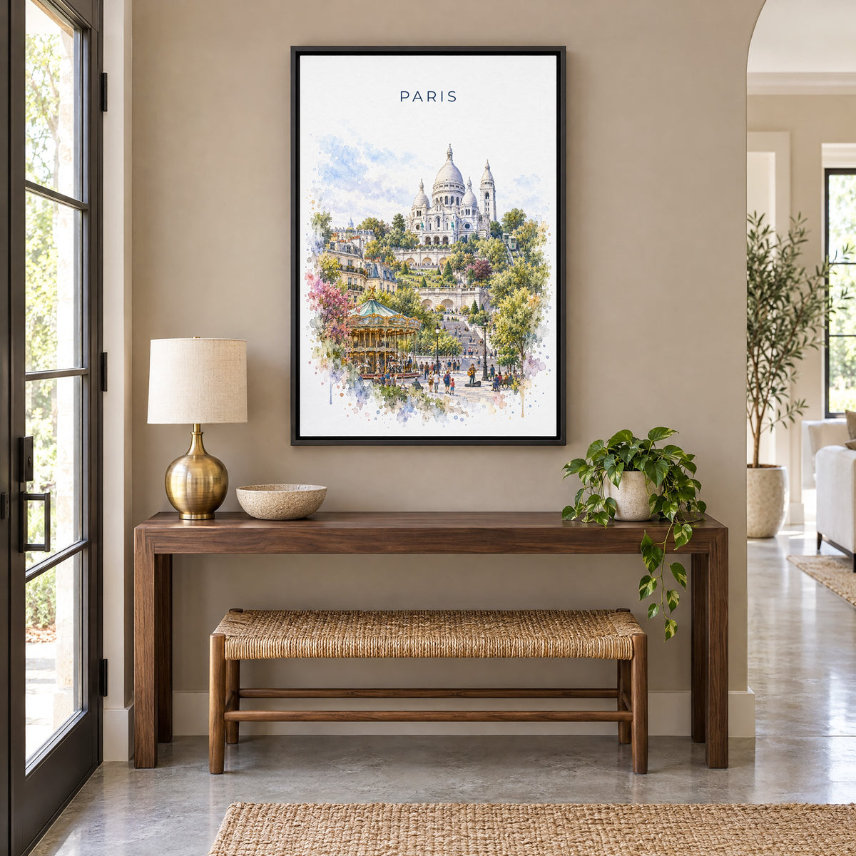 Montmartre Paris watercolor print as a black floater canvas above a walnut console and woven bench in an entryway