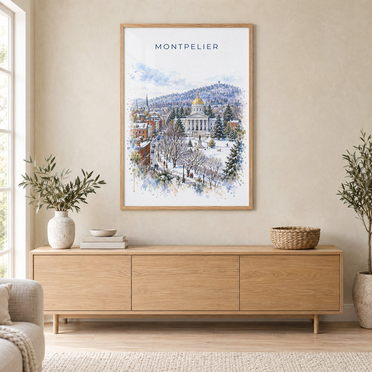 Montpelier watercolor print in an oak frame above a light wood sideboard in a Scandinavian living room