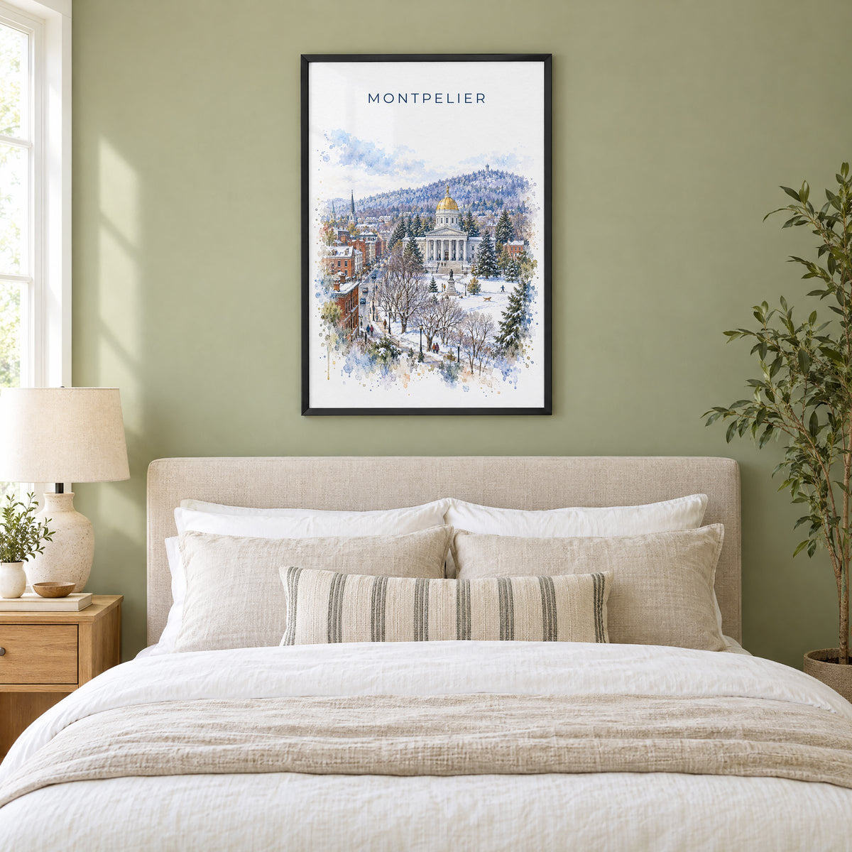 Montpelier watercolor print in a black frame above an upholstered headboard in a sage green bedroom