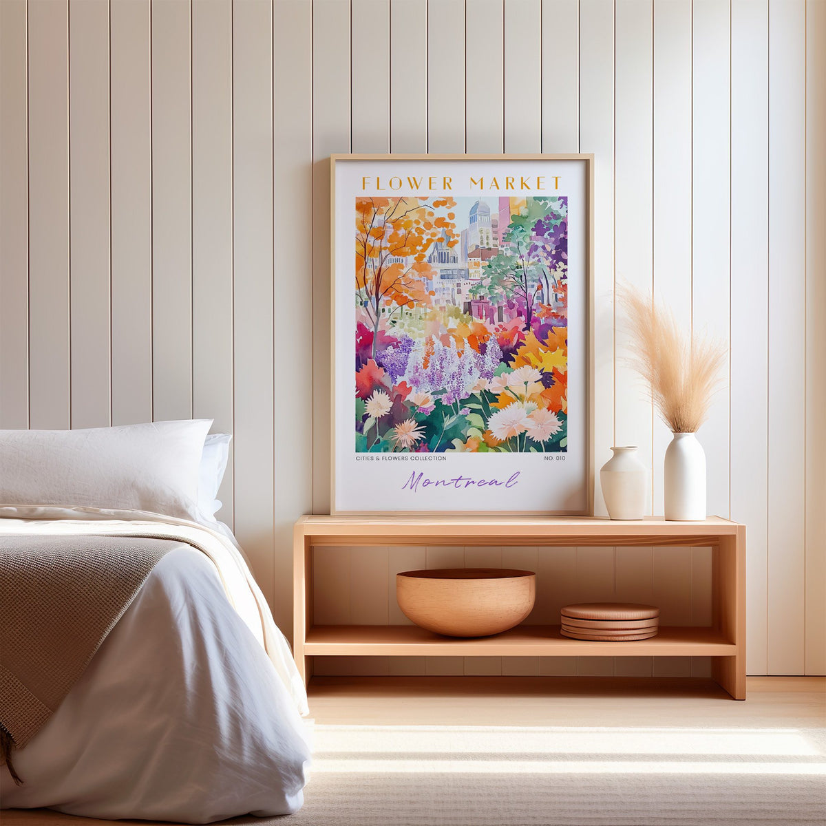 Montreal flower market print in an oak frame on a wood bench against a white shiplap bedroom wall with pampas grass