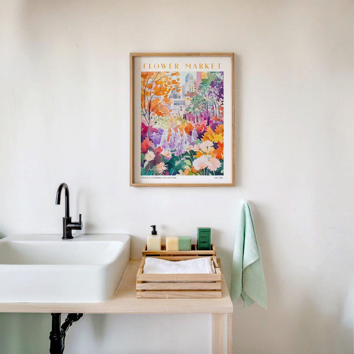 Montreal flower market print in an oak frame above a white bathroom sink with folded towels