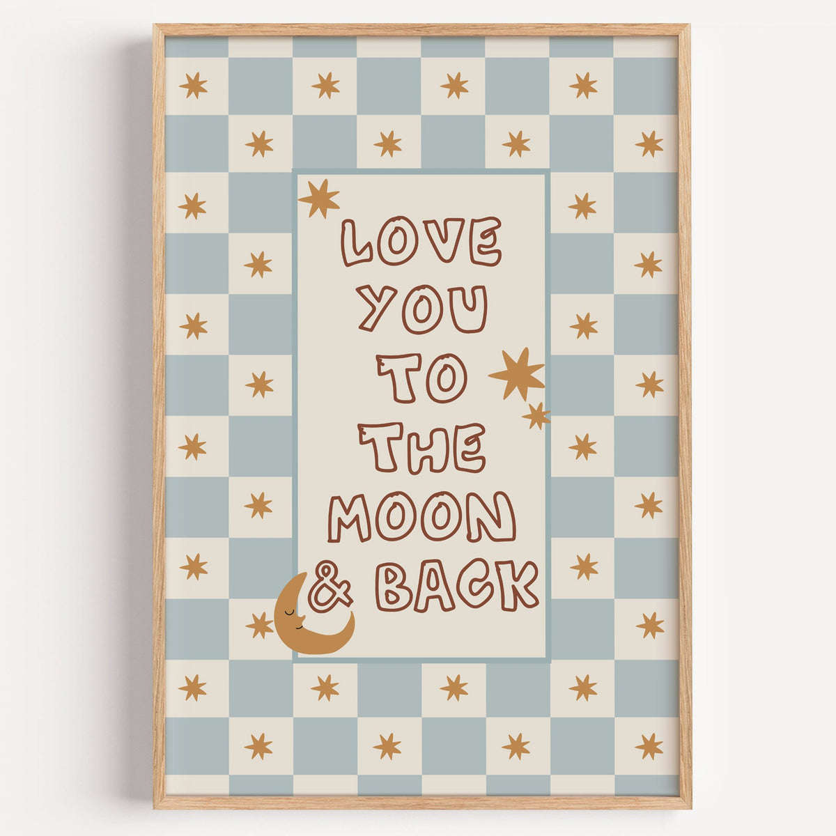 Love you to the moon nursery print in a light oak frame on a plain white wall