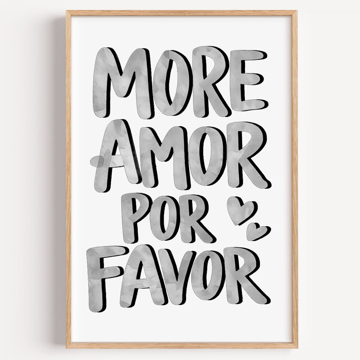 More amor por favor grey lettering print in a light oak frame on a plain white wall