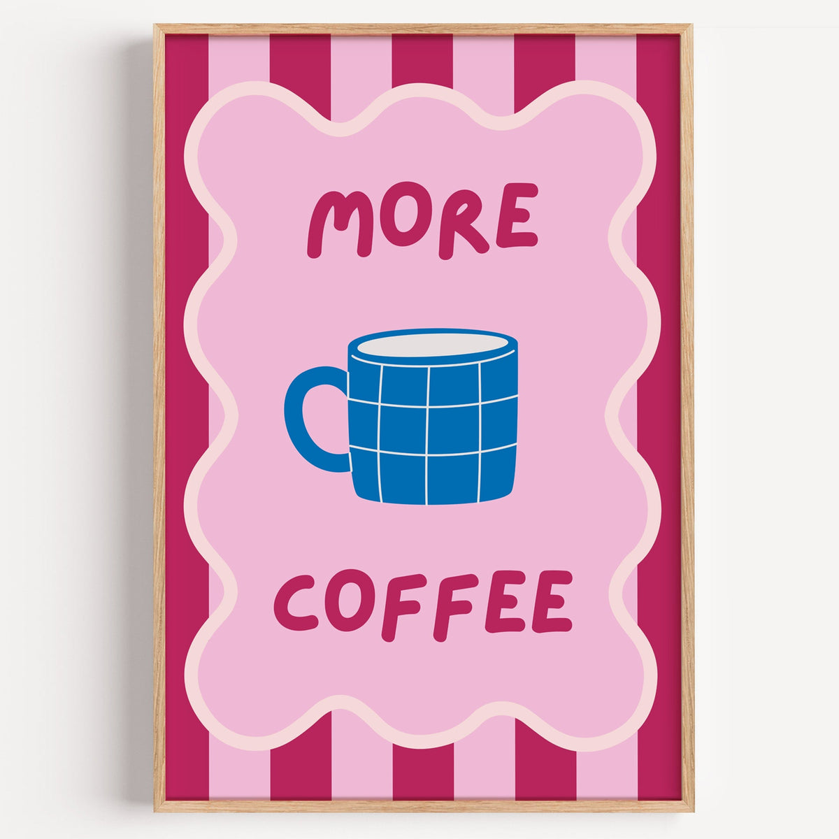 More Coffee blue mug print in a light oak frame on a plain white wall