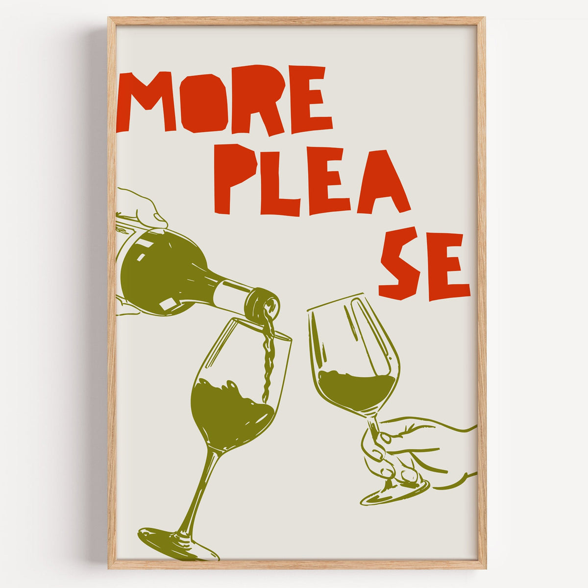 More Please wine pour print in a light oak frame on a plain white wall