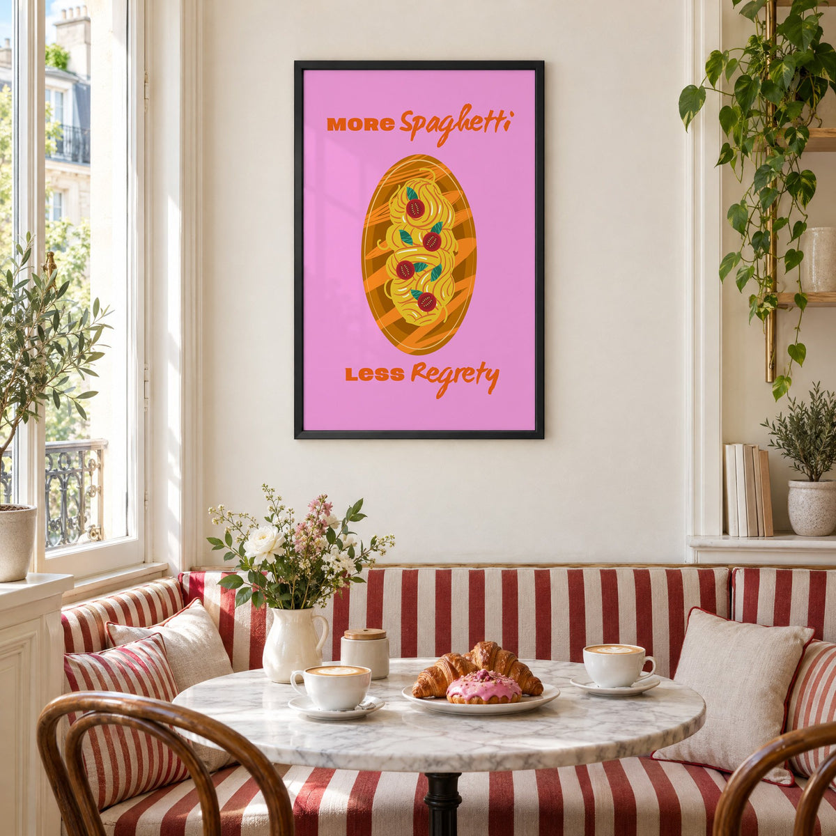 MORE Spaghetti LESS Regrety pasta plate print in a black frame above a striped cafe breakfast nook with cappuccino and pastries