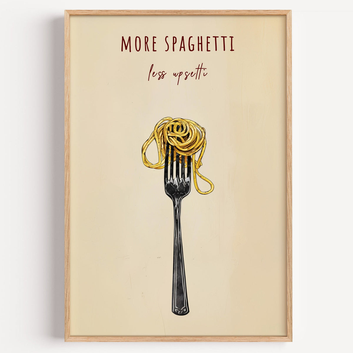 More Spaghetti Less Upsetti print in a light oak frame on a plain white wall