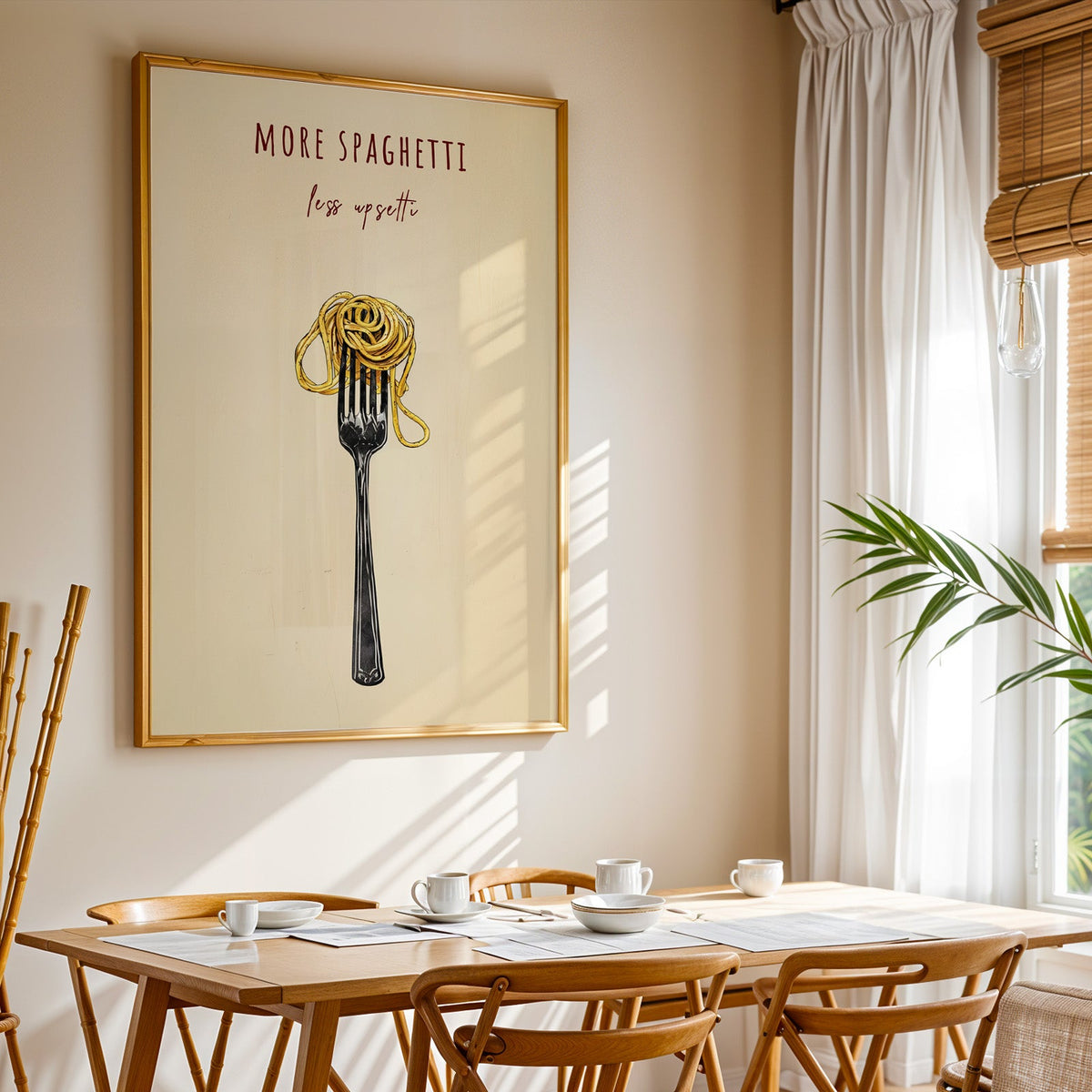 More Spaghetti Less Upsetti print shown in a gold frame above a breakfast table by a curtained window