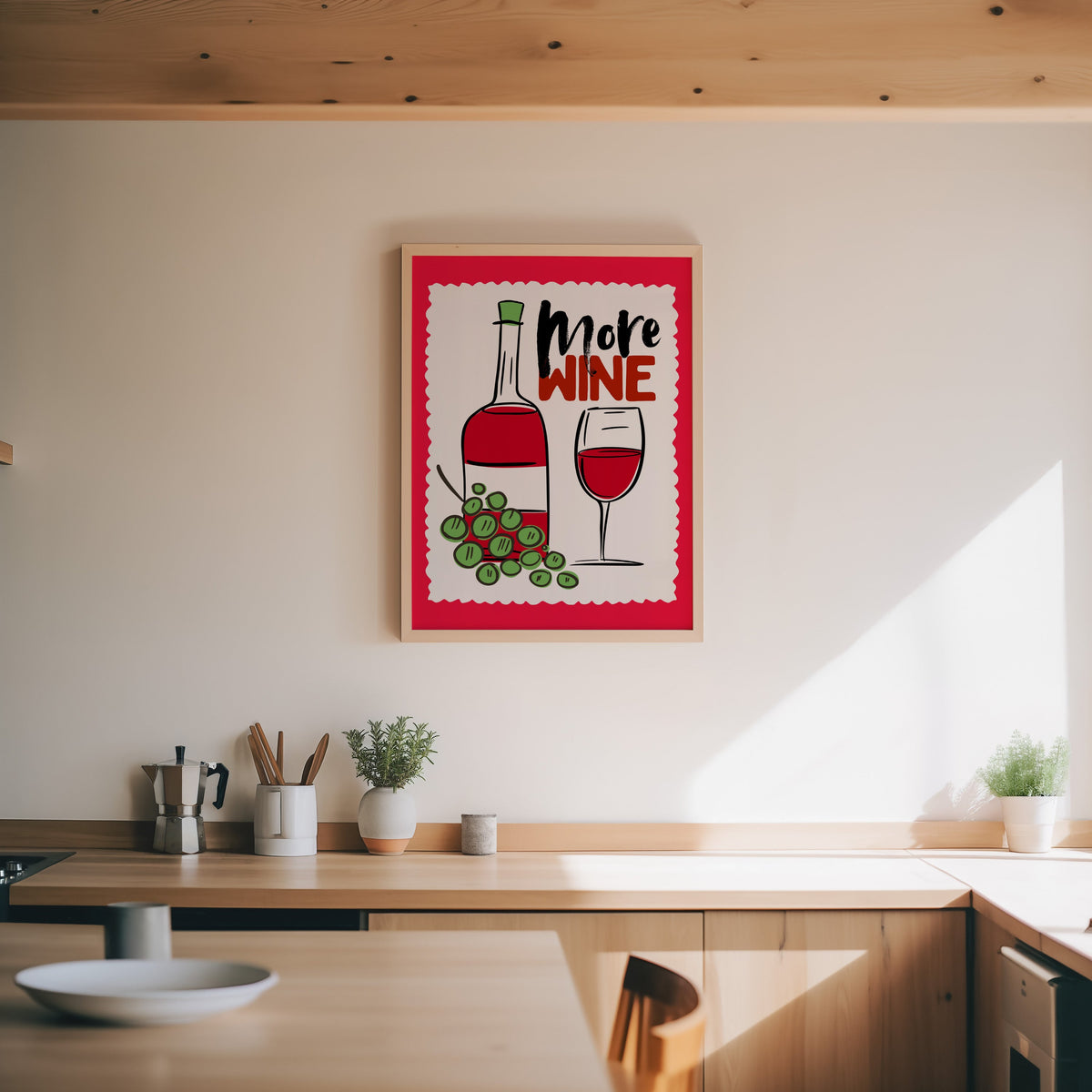 More Wine print in an oak frame above a wood counter with a moka pot and herbs