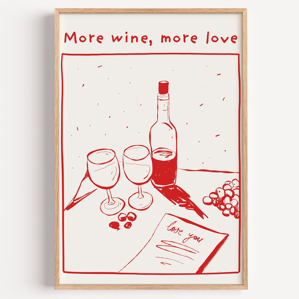 More Wine More Love red line print in a light oak frame on a plain white wall
