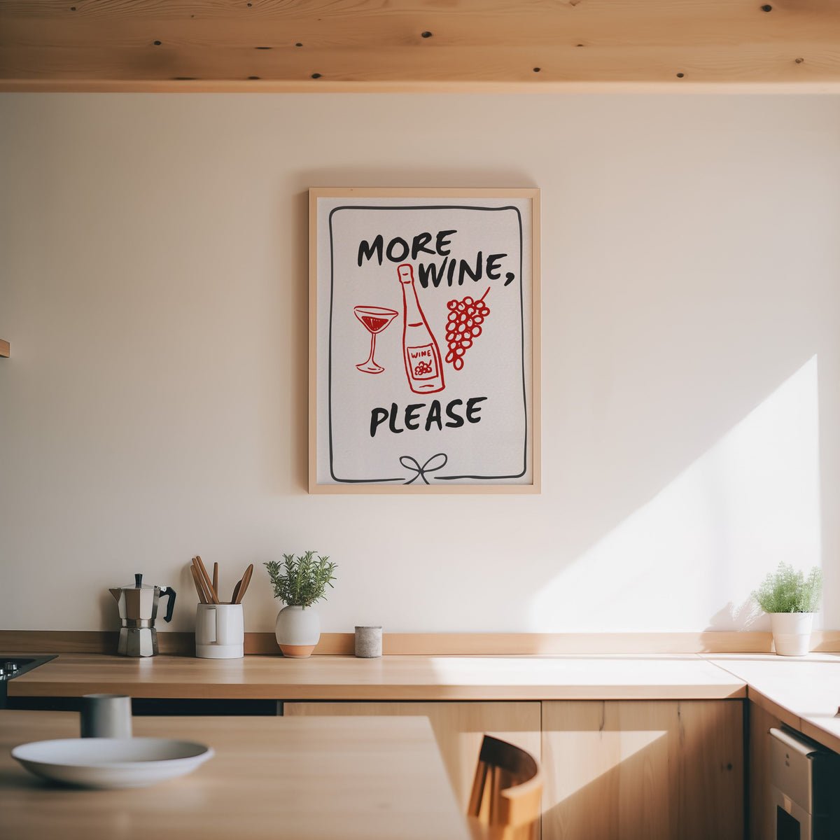 More Wine Please print in an oak frame above a wood counter with a moka pot and herbs