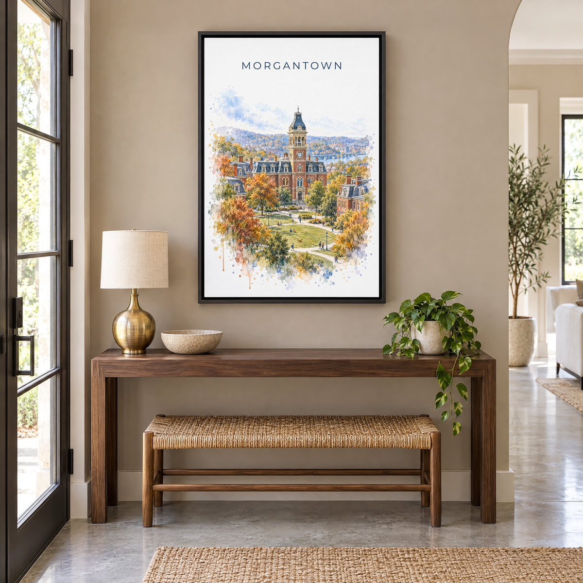Morgantown watercolor print as a black floater canvas above a walnut console and woven bench in an entryway