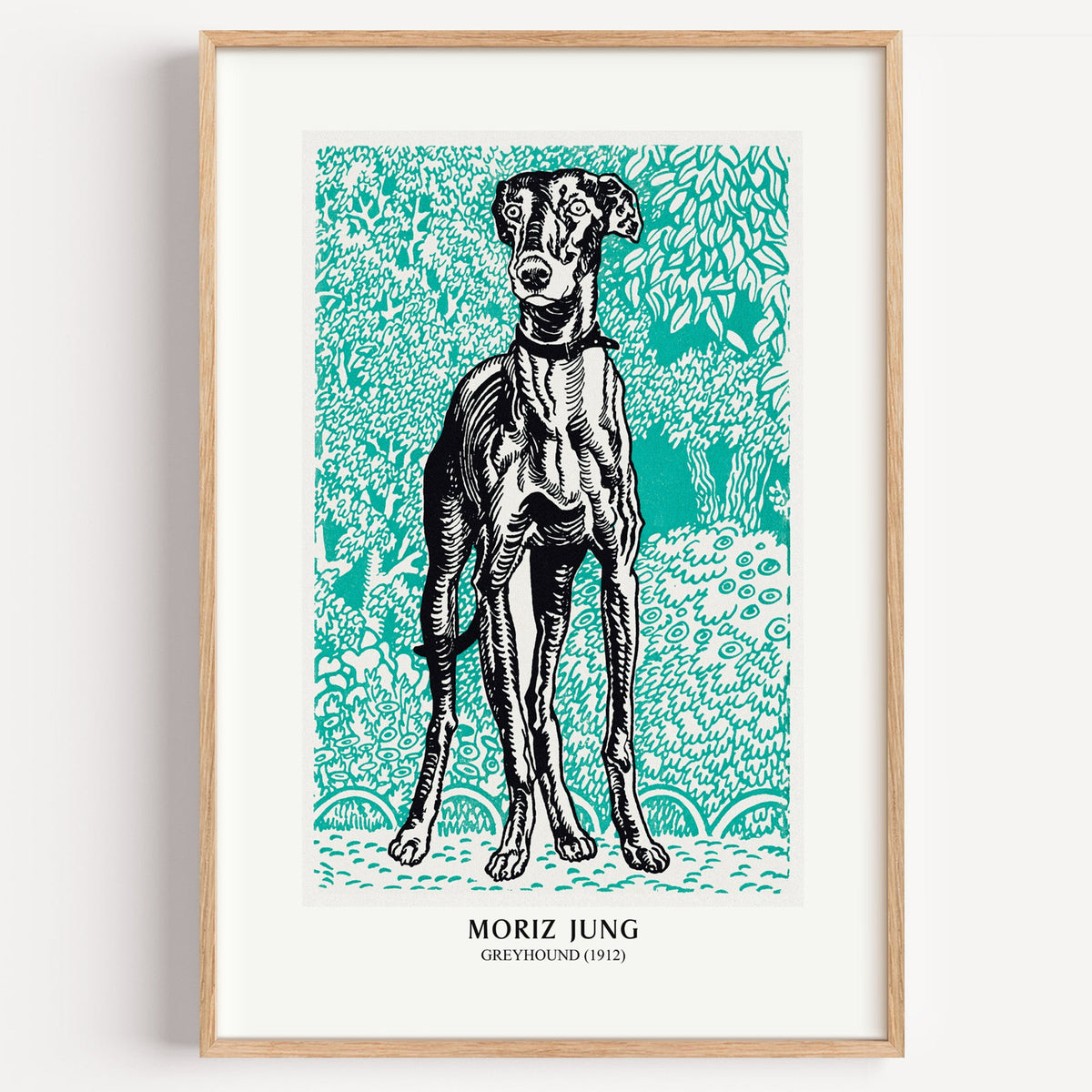 Moriz Jung Greyhound print in a light oak frame on a plain white wall