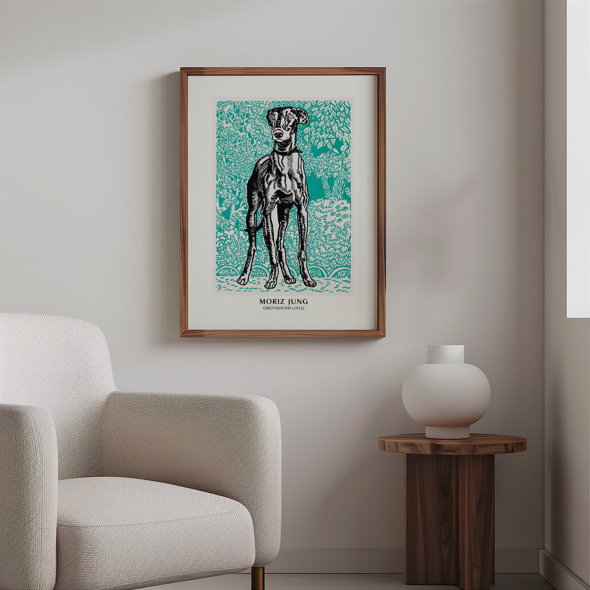 Greyhound graphic print in a slim walnut frame above a bouclé armchair