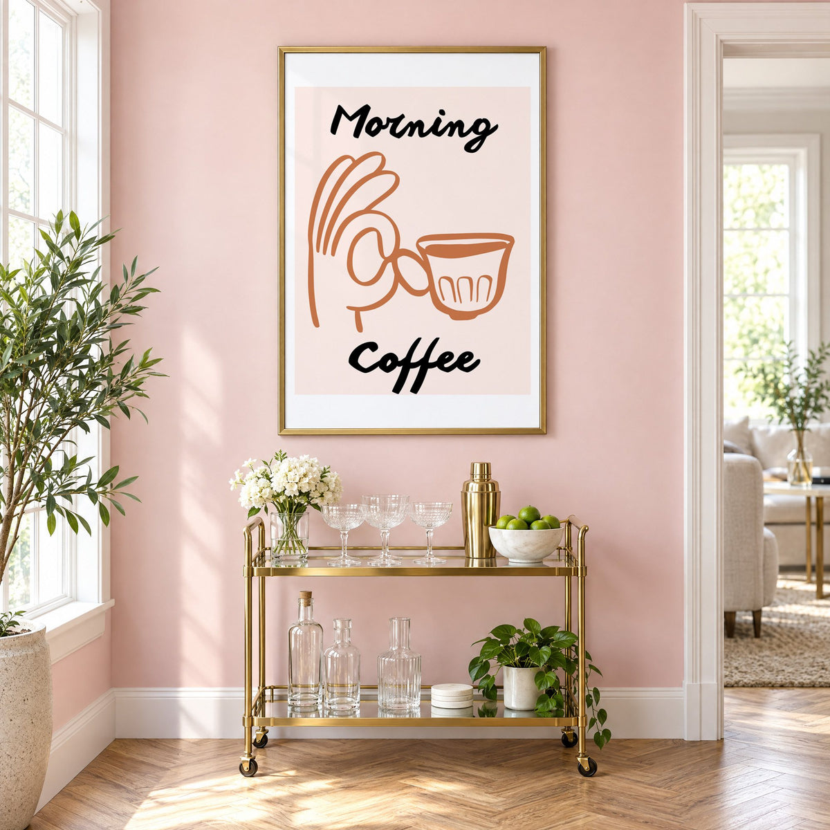 Morning Coffee terracotta hand cup print in a brass frame above a gold bar cart on a blush pink wall