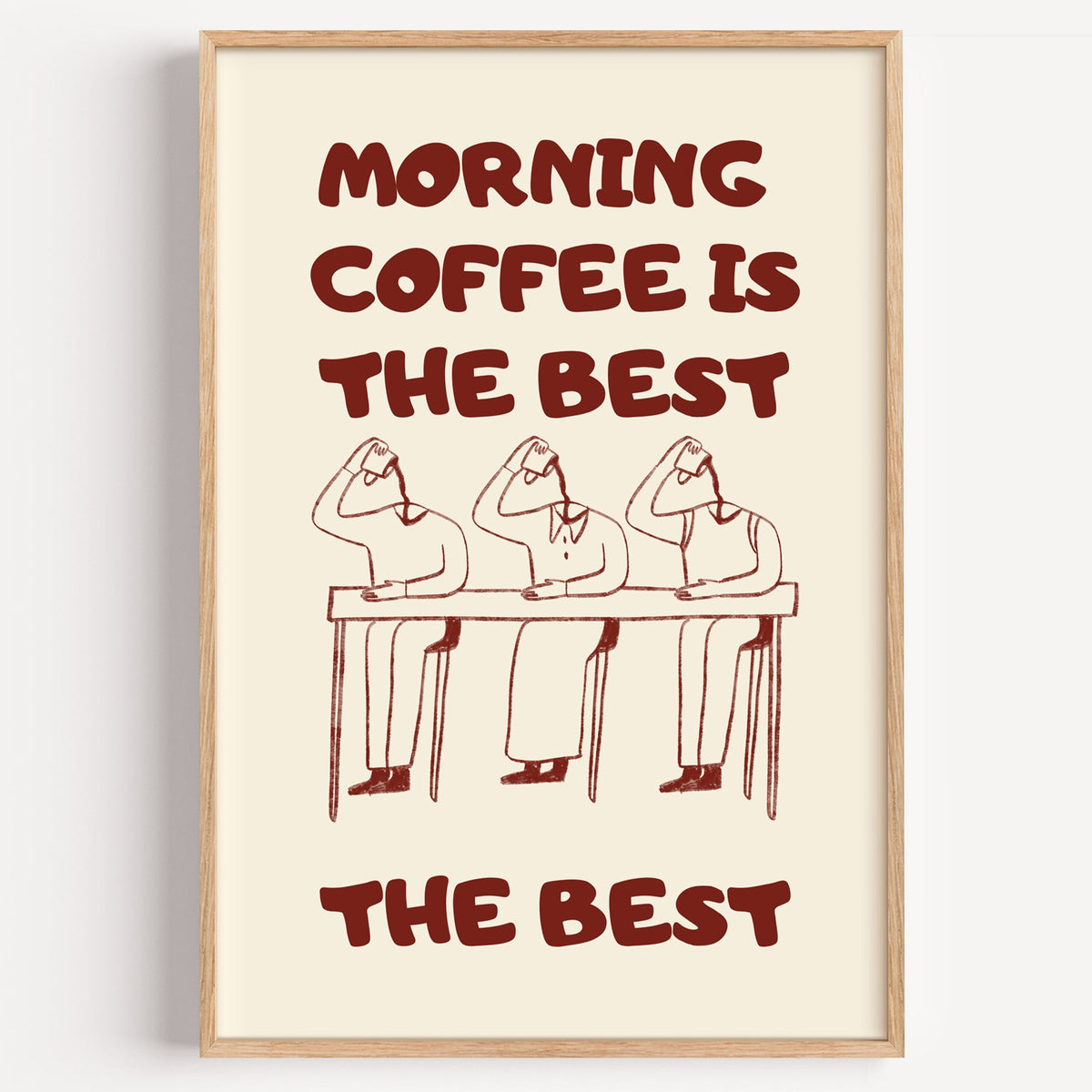 Morning Coffee Is The Best print in a light oak frame on a plain white wall
