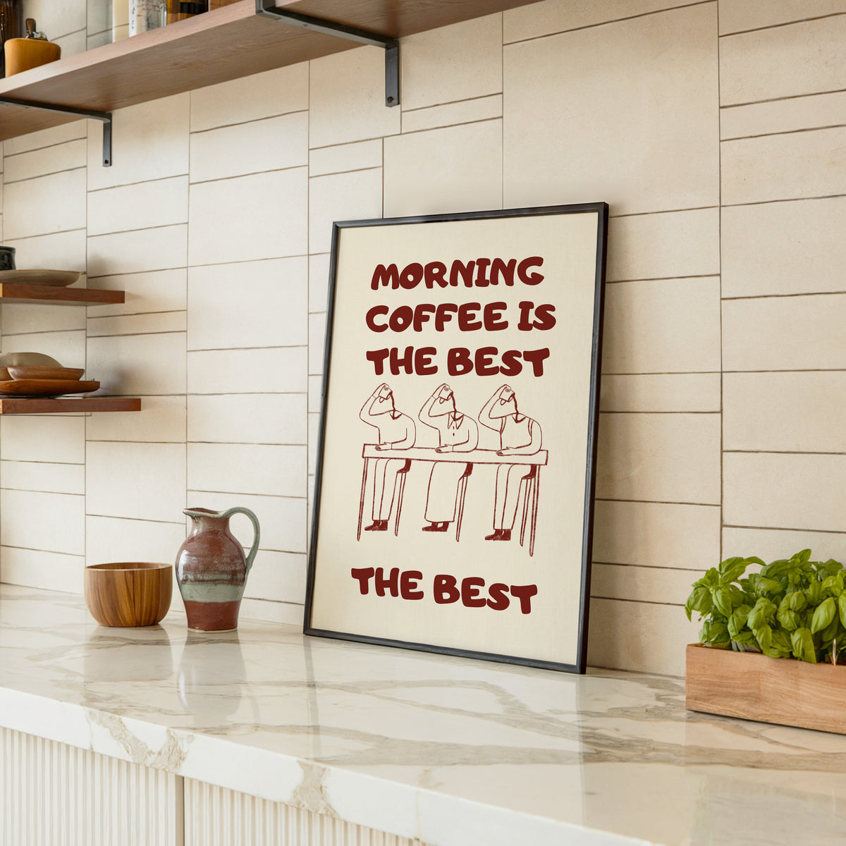 Morning Coffee Is The Best print in a black frame leaning on a marble counter in a tiled kitchen