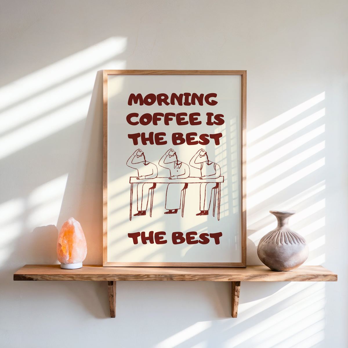 Morning Coffee Is The Best print in an oak frame on a live-edge shelf beside a salt lamp