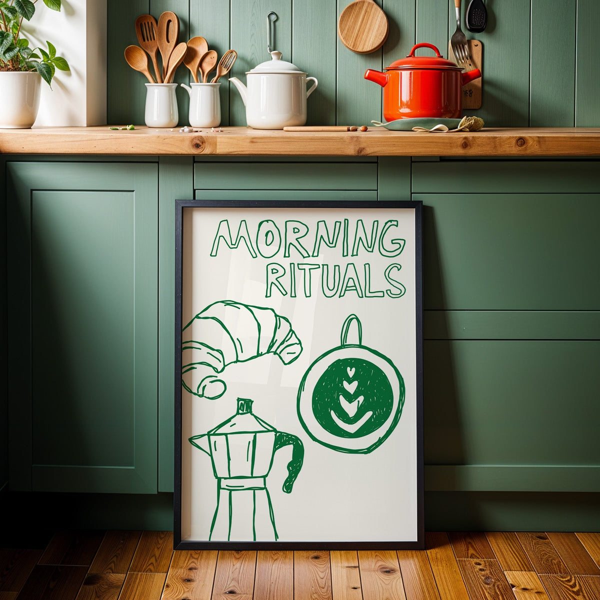 Morning rituals coffee line print in a black frame against sage green kitchen cabinets