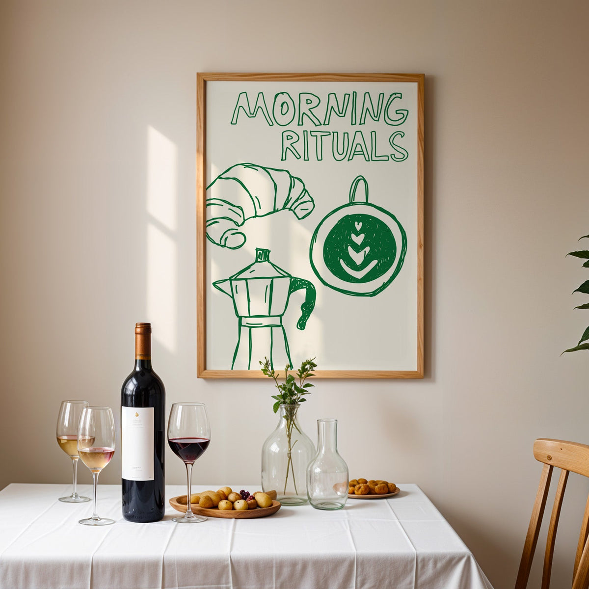 Morning rituals coffee line print in an oak frame above a table laid with red wine