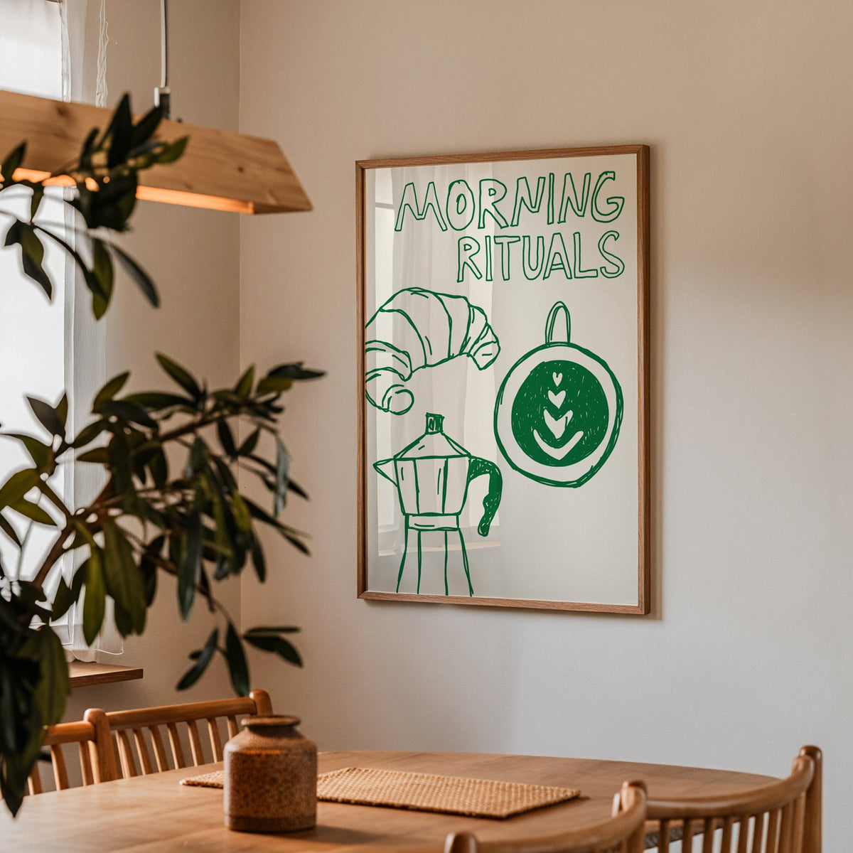 Morning rituals coffee line print in a walnut frame above a table beside an olive tree