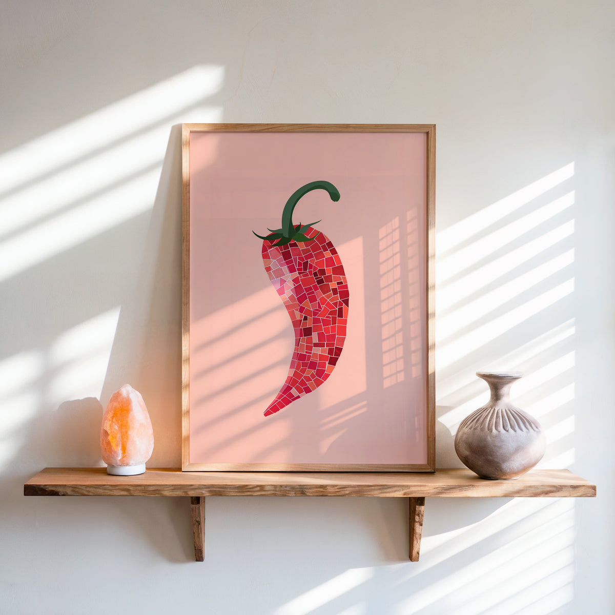 Mosaic chilli print in an oak frame on a live-edge shelf beside a salt lamp