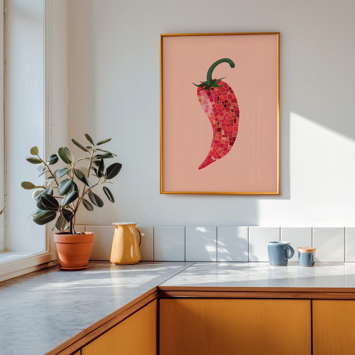 Mosaic chilli print shown in a gold frame above a marble counter in a tan kitchen