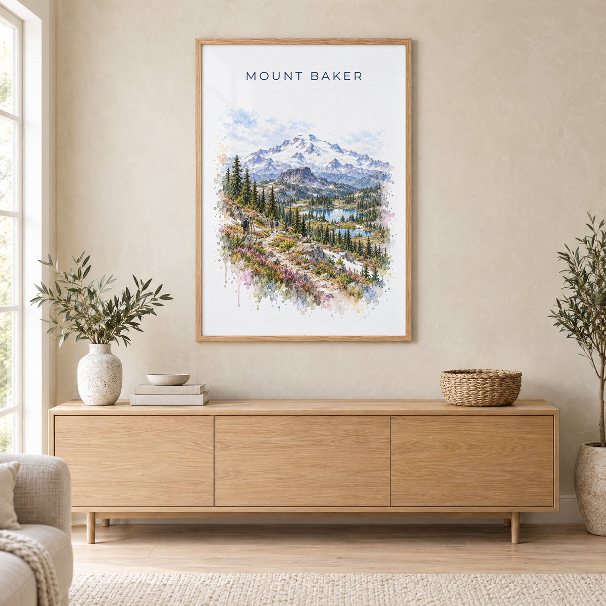 Mount Baker watercolor print in an oak frame above a light wood sideboard in a Scandinavian living room