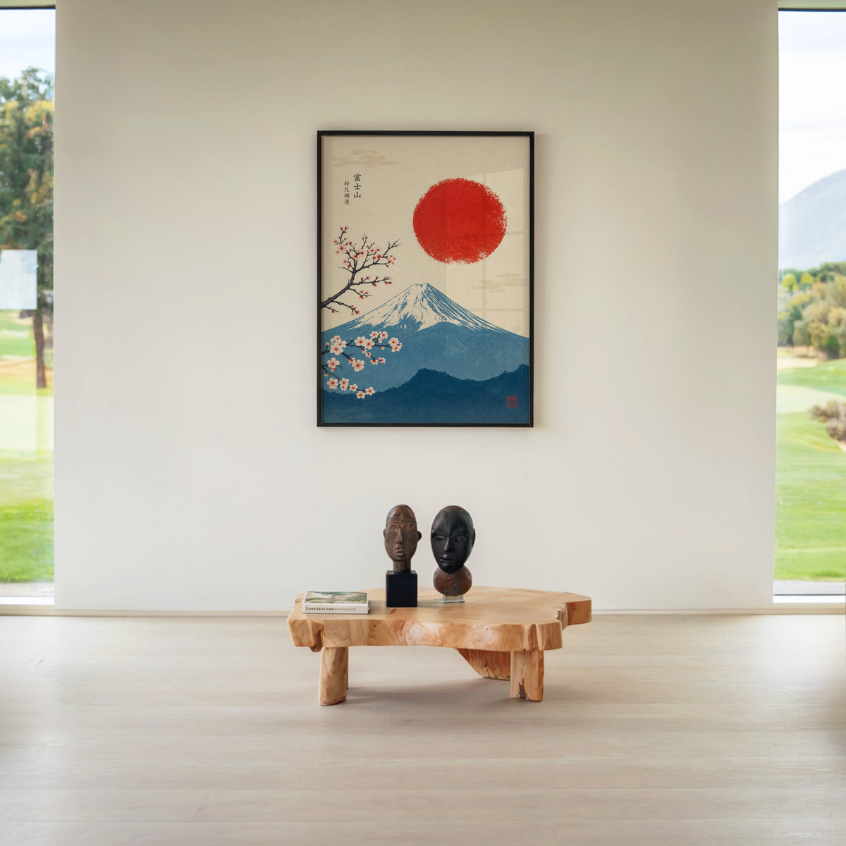 blue Mount Fuji with red sun and sakura print in a black frame above a live-edge wood coffee table between garden windows