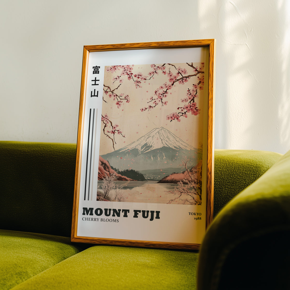 Mount Fuji cherry blooms lake print in an oak frame propped on a green velvet sofa