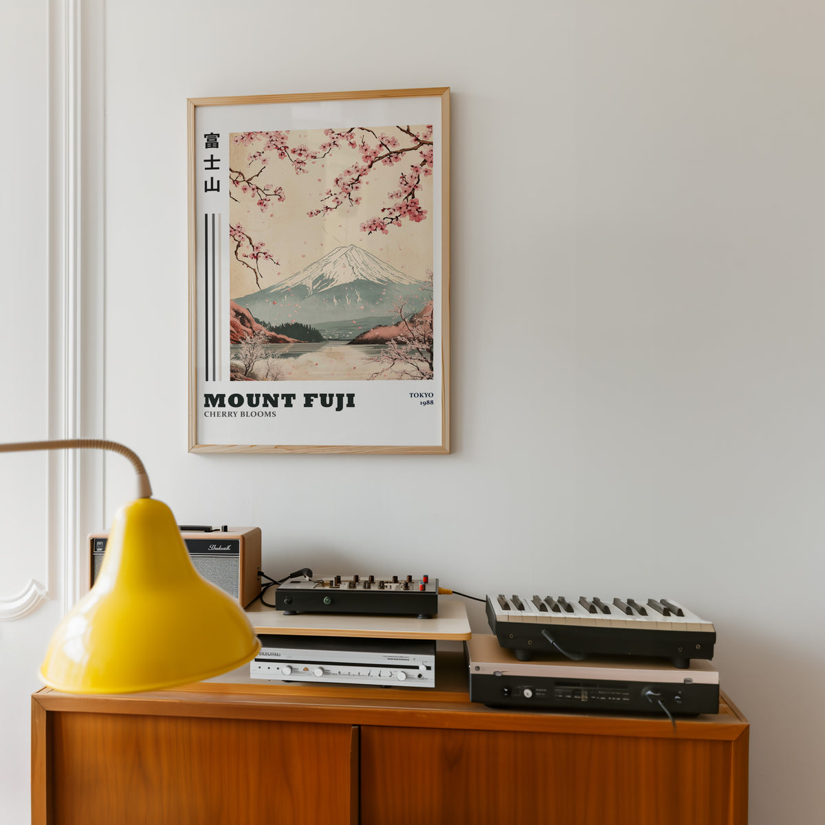 Mount Fuji cherry blooms lake print in an oak frame above a teak sideboard with vintage hi-fi