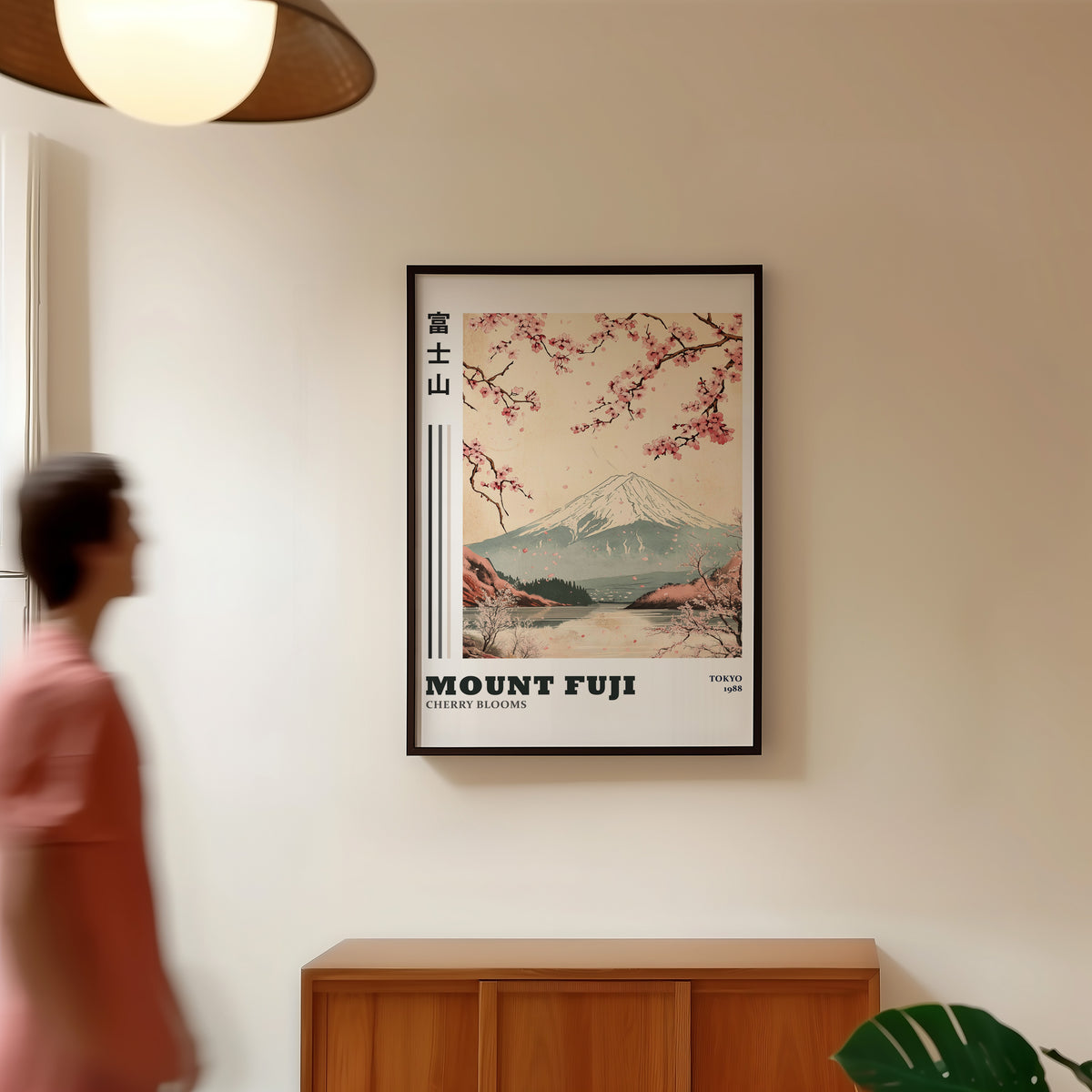 Mount Fuji cherry blooms lake print in a black frame in a hallway under a rattan pendant