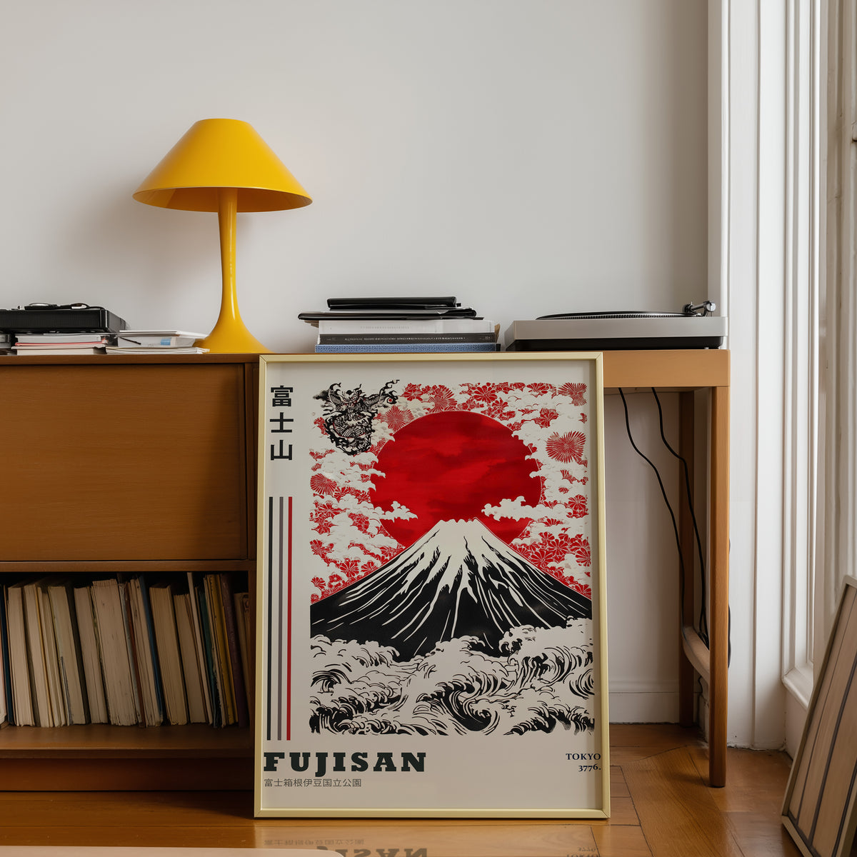 Red sun Mount Fuji floral wave print shown in a gold frame below a teak desk with a yellow lamp