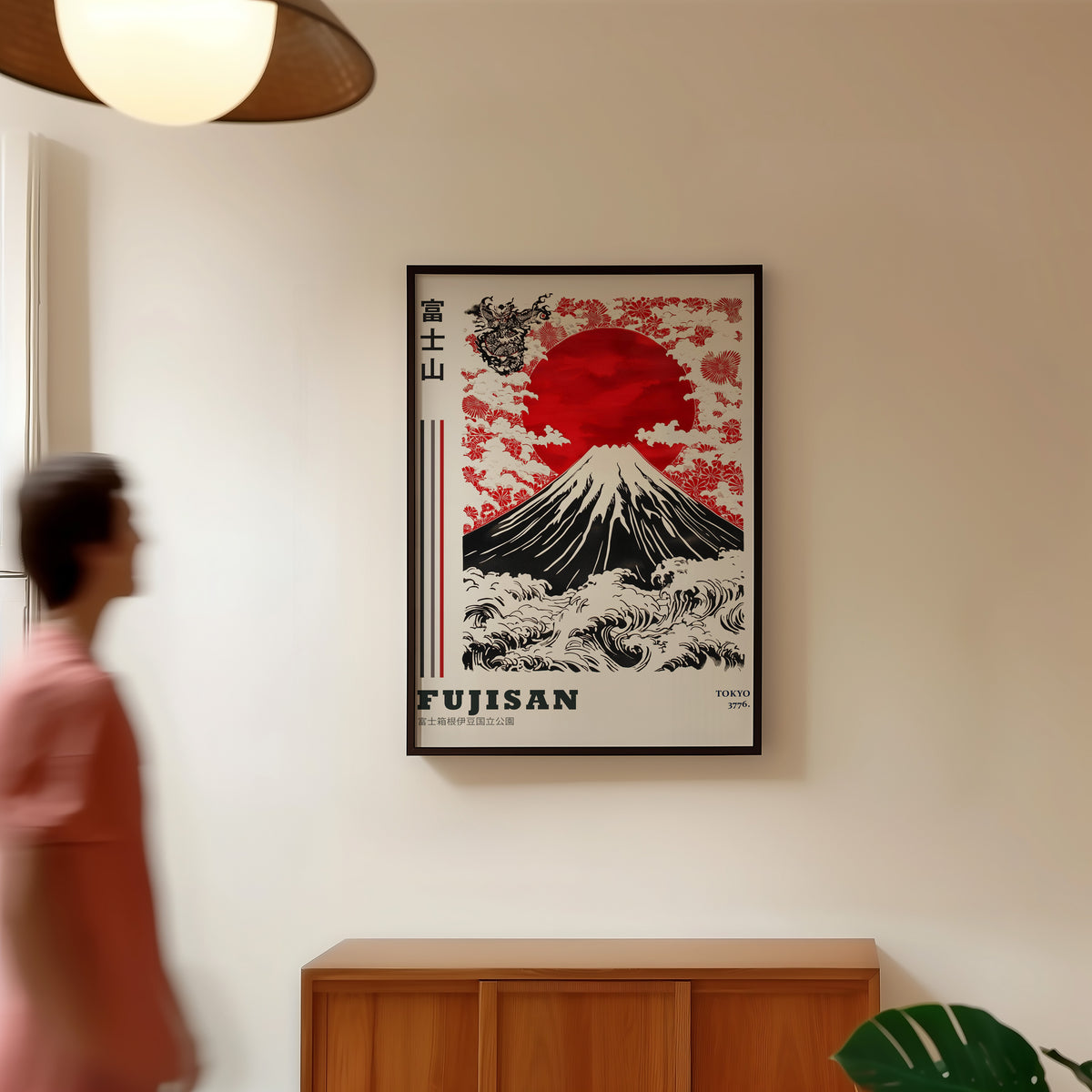 Red sun Mount Fuji floral wave print in a black frame in a hallway under a rattan pendant