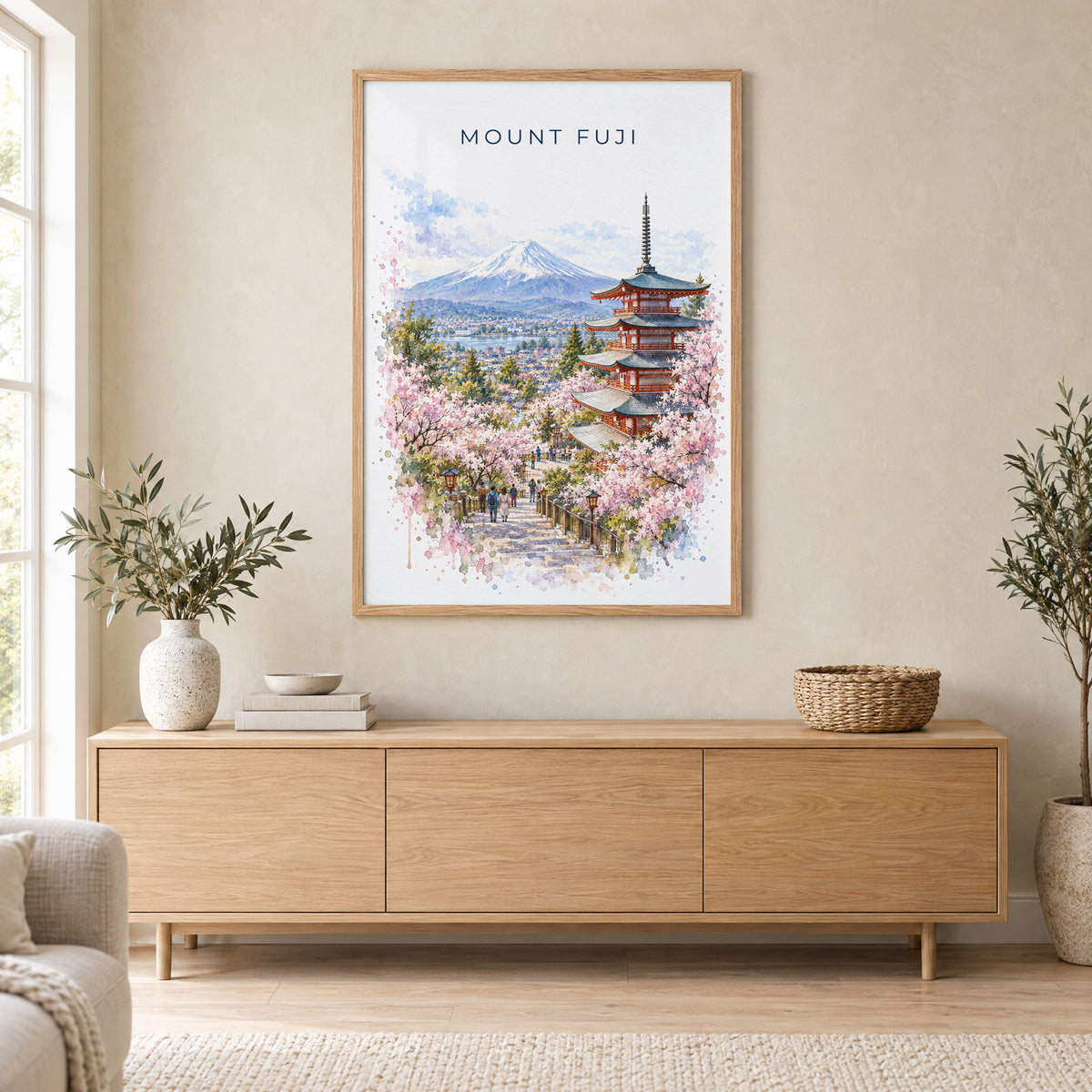 Mount Fuji watercolor print in an oak frame above a light wood sideboard in a Scandinavian living room