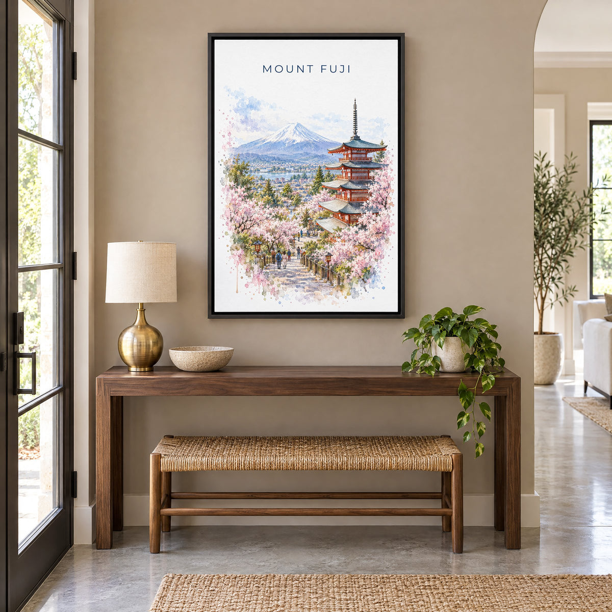 Mount Fuji watercolor print as a black floater canvas above a walnut console and woven bench in an entryway