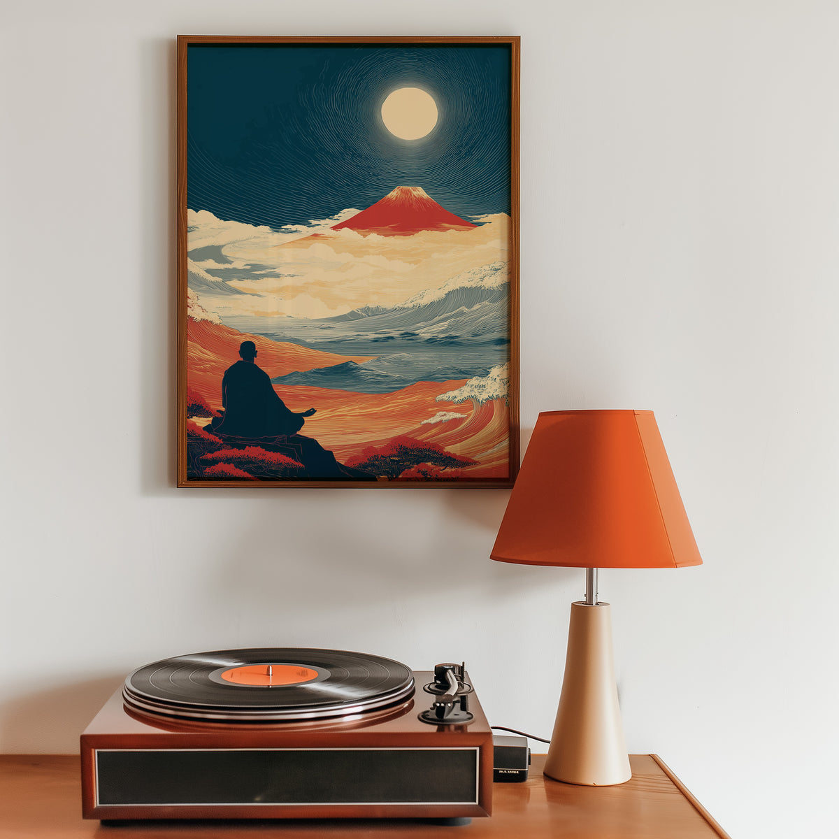 Meditating monk and red Fuji print in a walnut frame above a sideboard with a record player