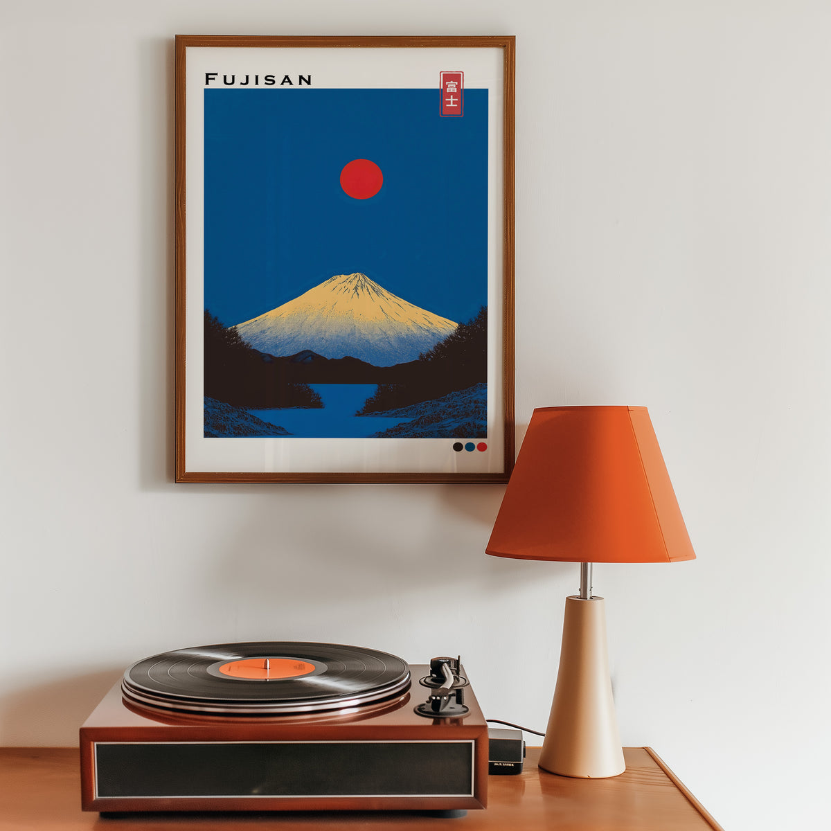 Minimal golden Mount Fuji print in a walnut frame above a sideboard with a record player