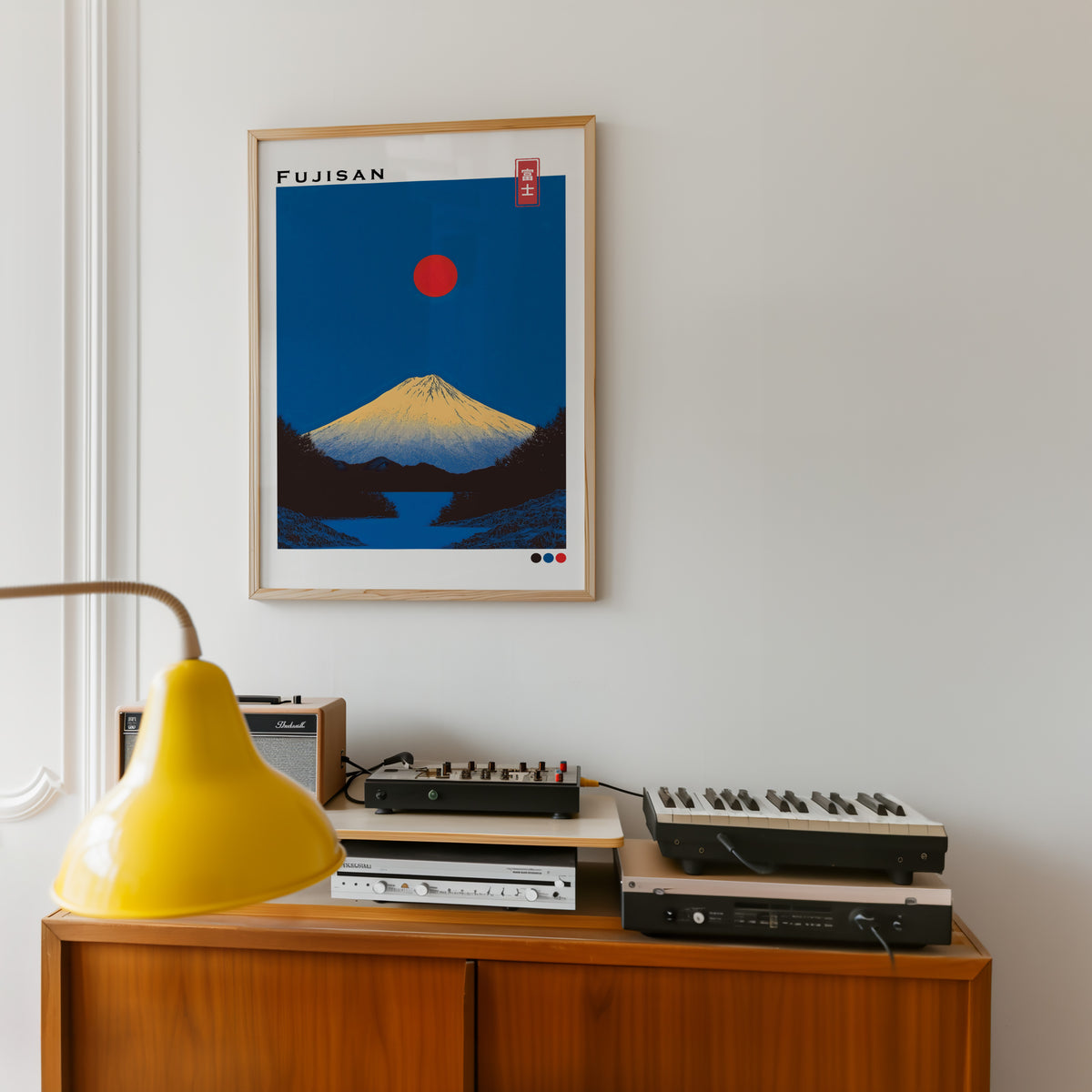 Minimal golden Mount Fuji print in an oak frame above a teak sideboard with vintage hi-fi