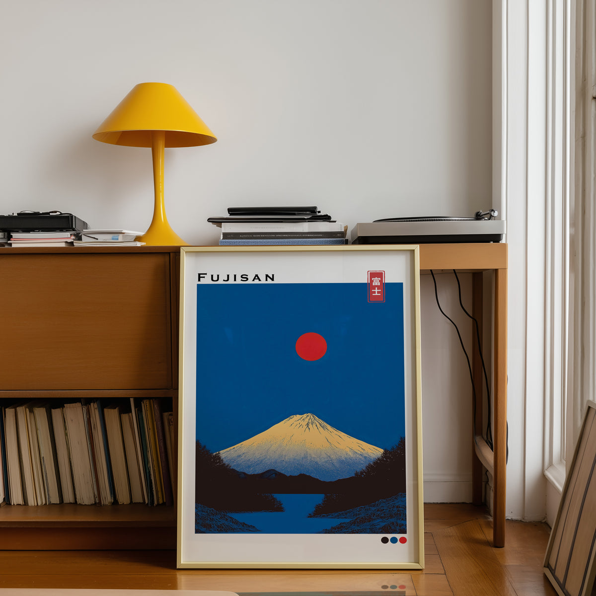 Minimal golden Mount Fuji print shown in a gold frame below a teak desk with a yellow lamp