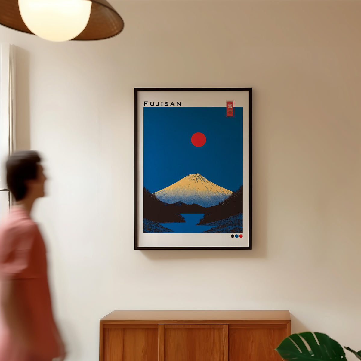 Minimal golden Mount Fuji print in a black frame in a hallway under a rattan pendant