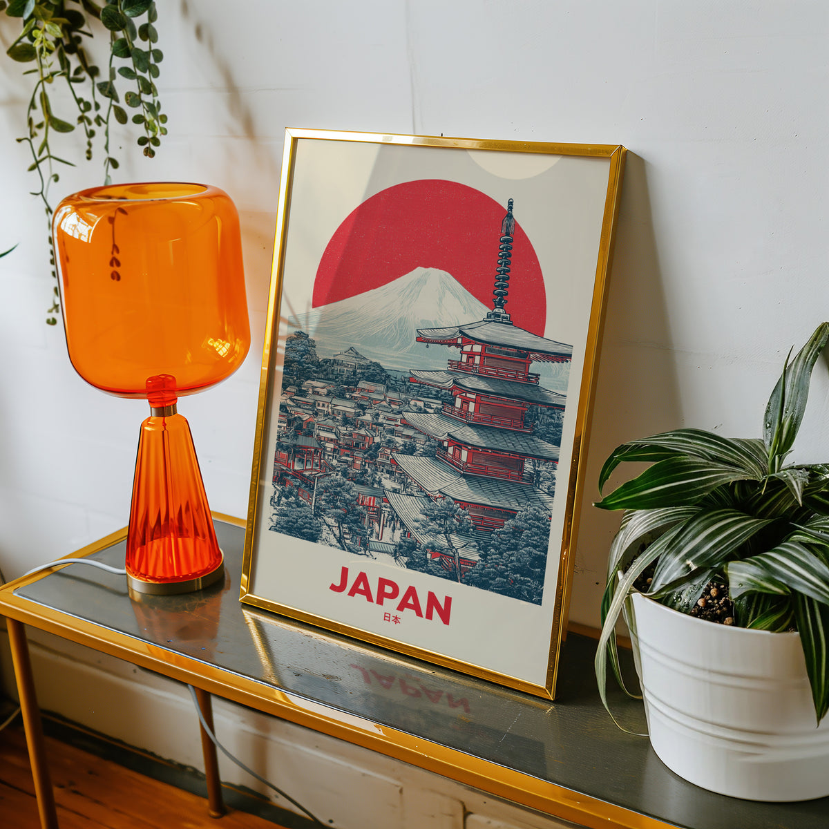 Retro Mount Fuji red pagoda print shown in a gold frame on a console beside an orange glass lamp